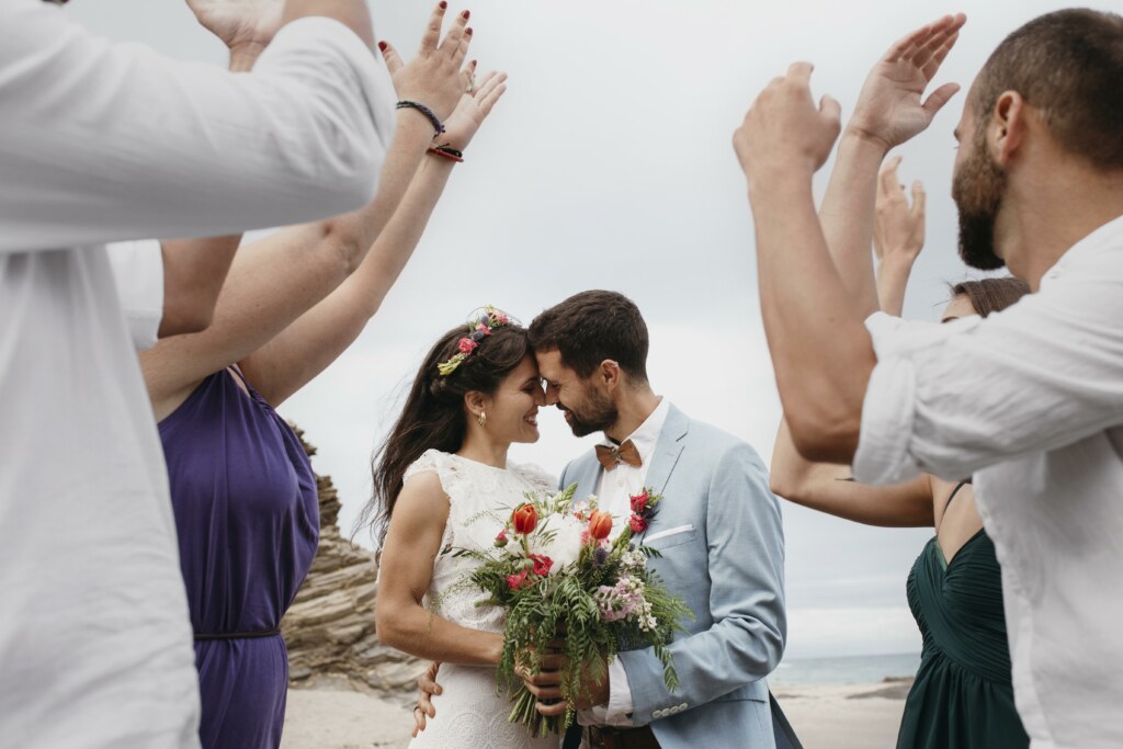 Wedding couple having their wedding ceremony by the beach