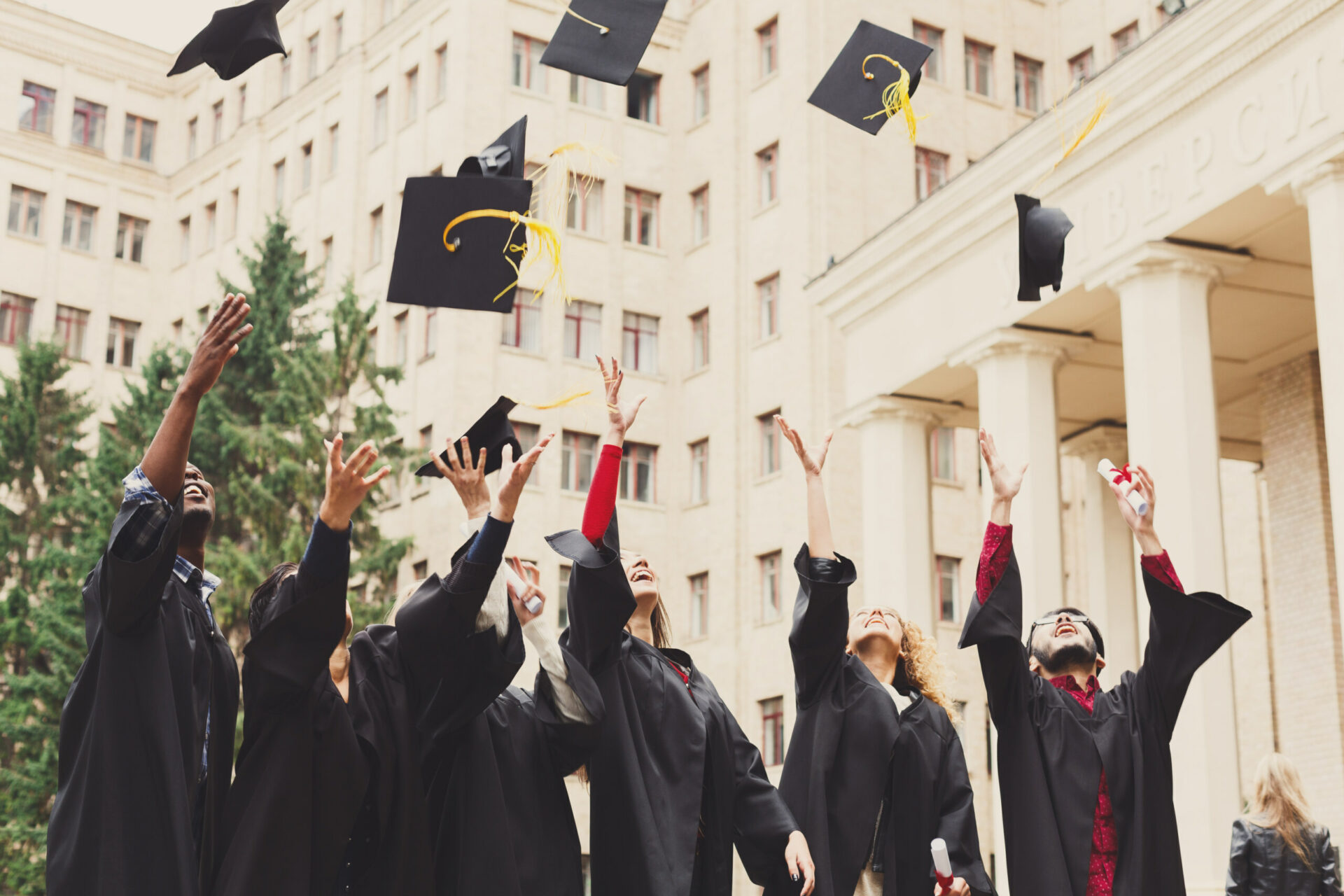 A group of graduates throwing graduation cap