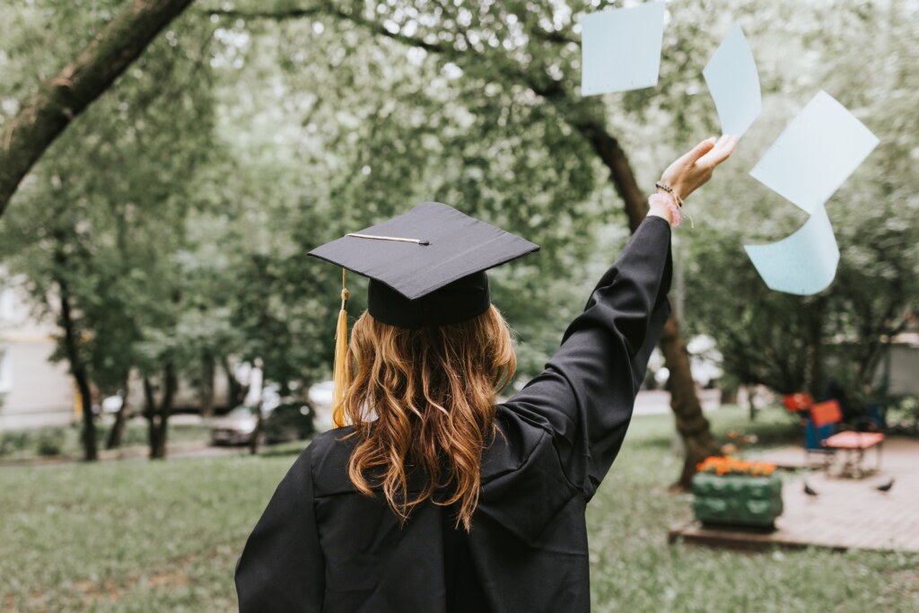 One graduate throwing papers