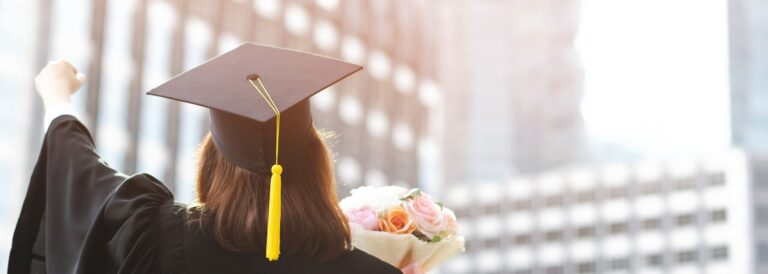 back side young female student holding flower bouquet on graduation ceremony